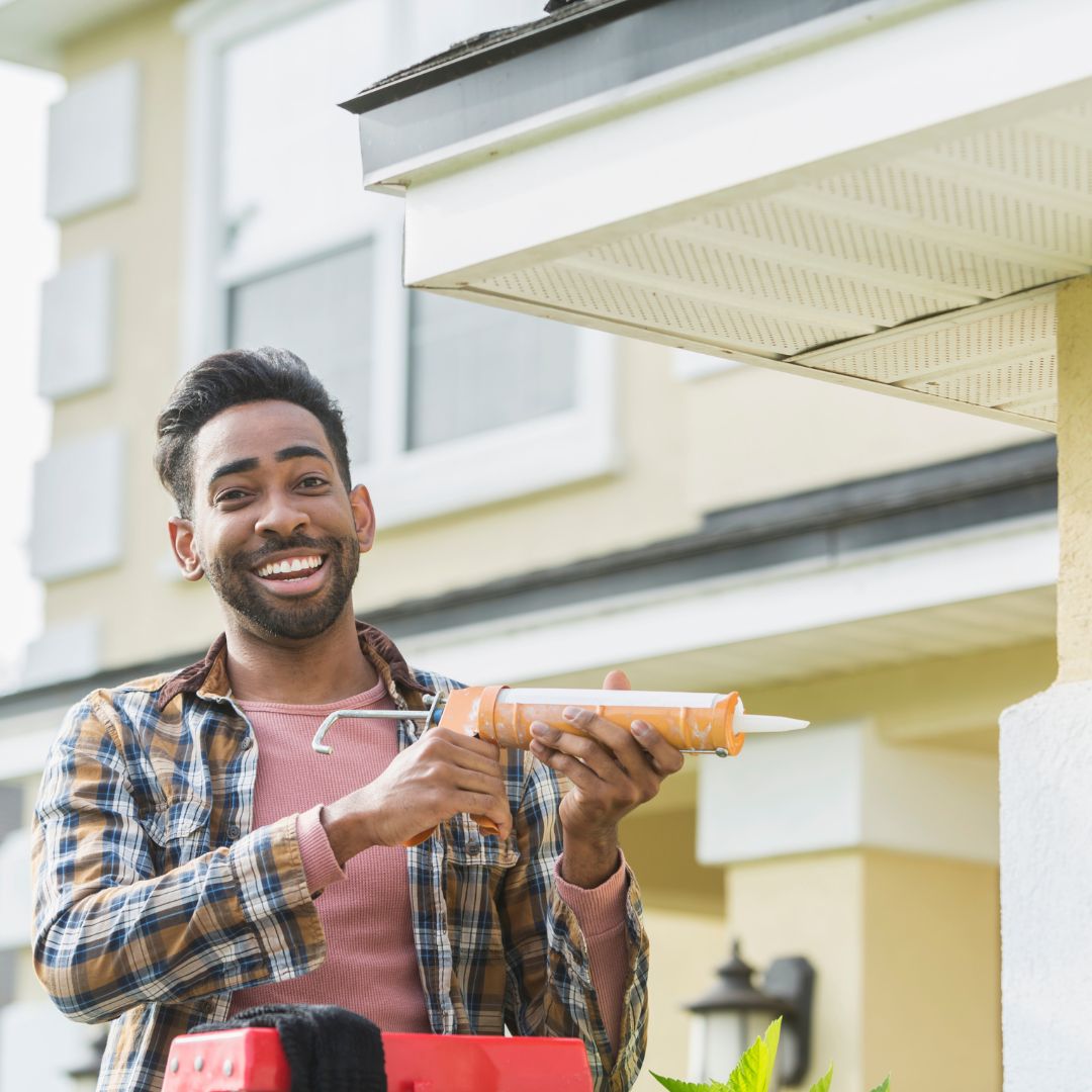 man repairing house